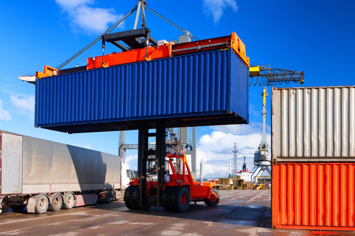 A crane moving a shipping container.